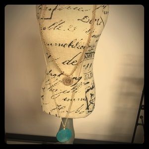 necklace with blue pendant and ottoman charm